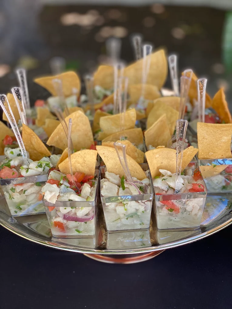 Individual ceviche appetizers with tortilla chips and mini forks