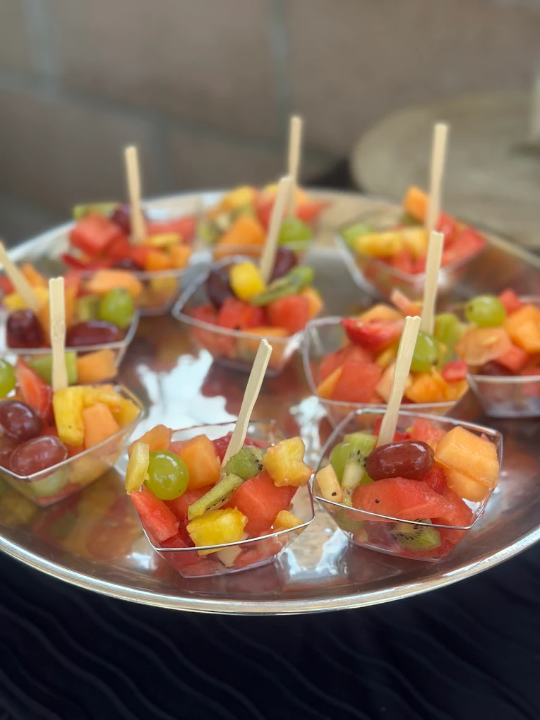 Colorful fresh fruit appetizers in clear individual bowls